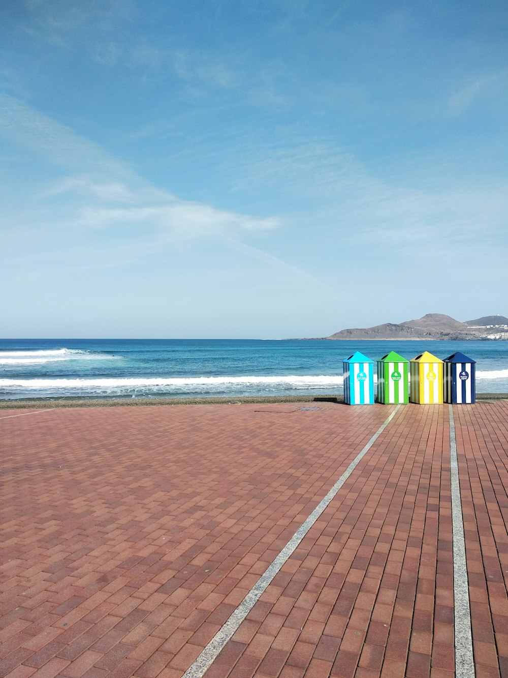 blue and green houses near sea under blue sky during daytime