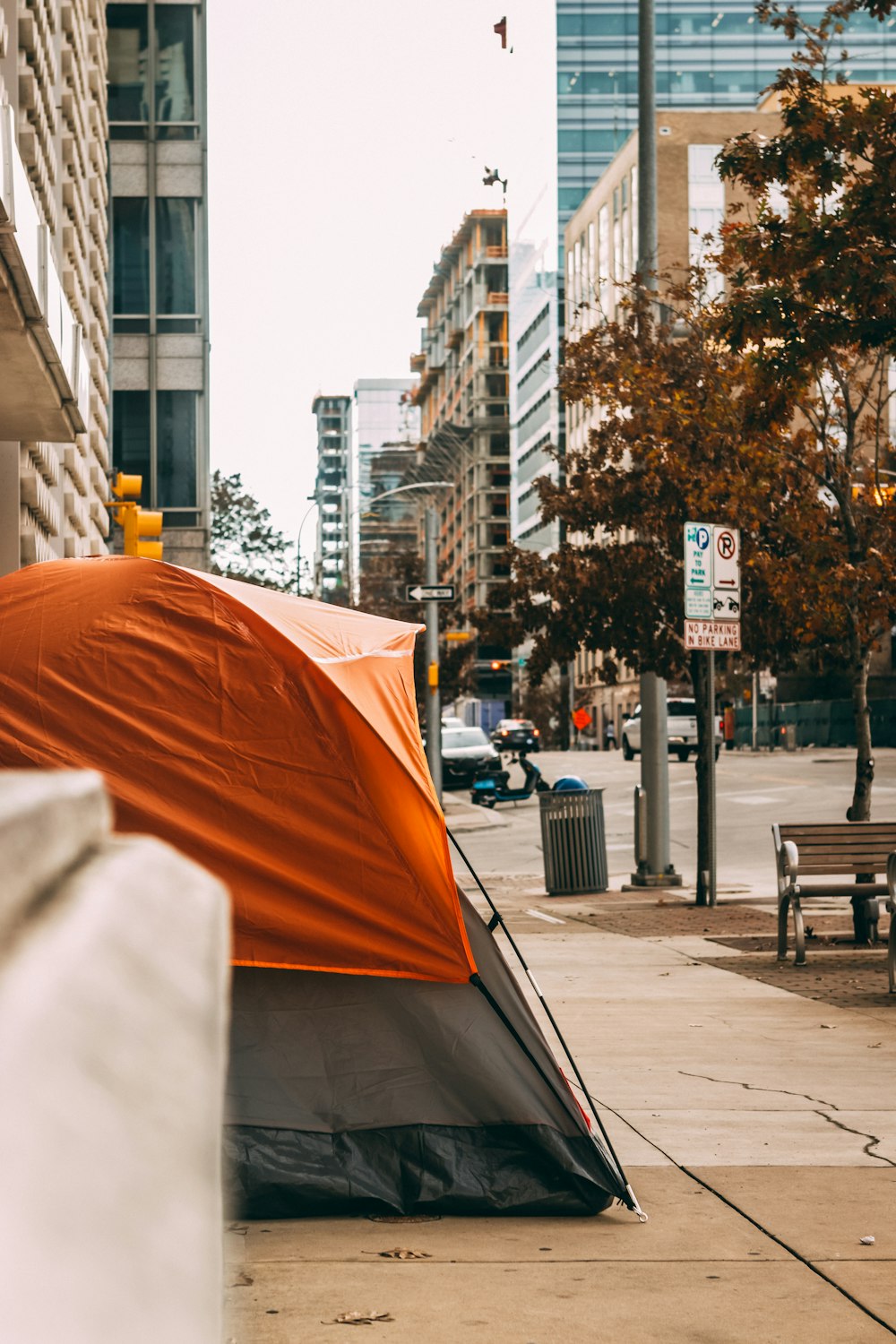 orange umbrella on sidewalk during daytime