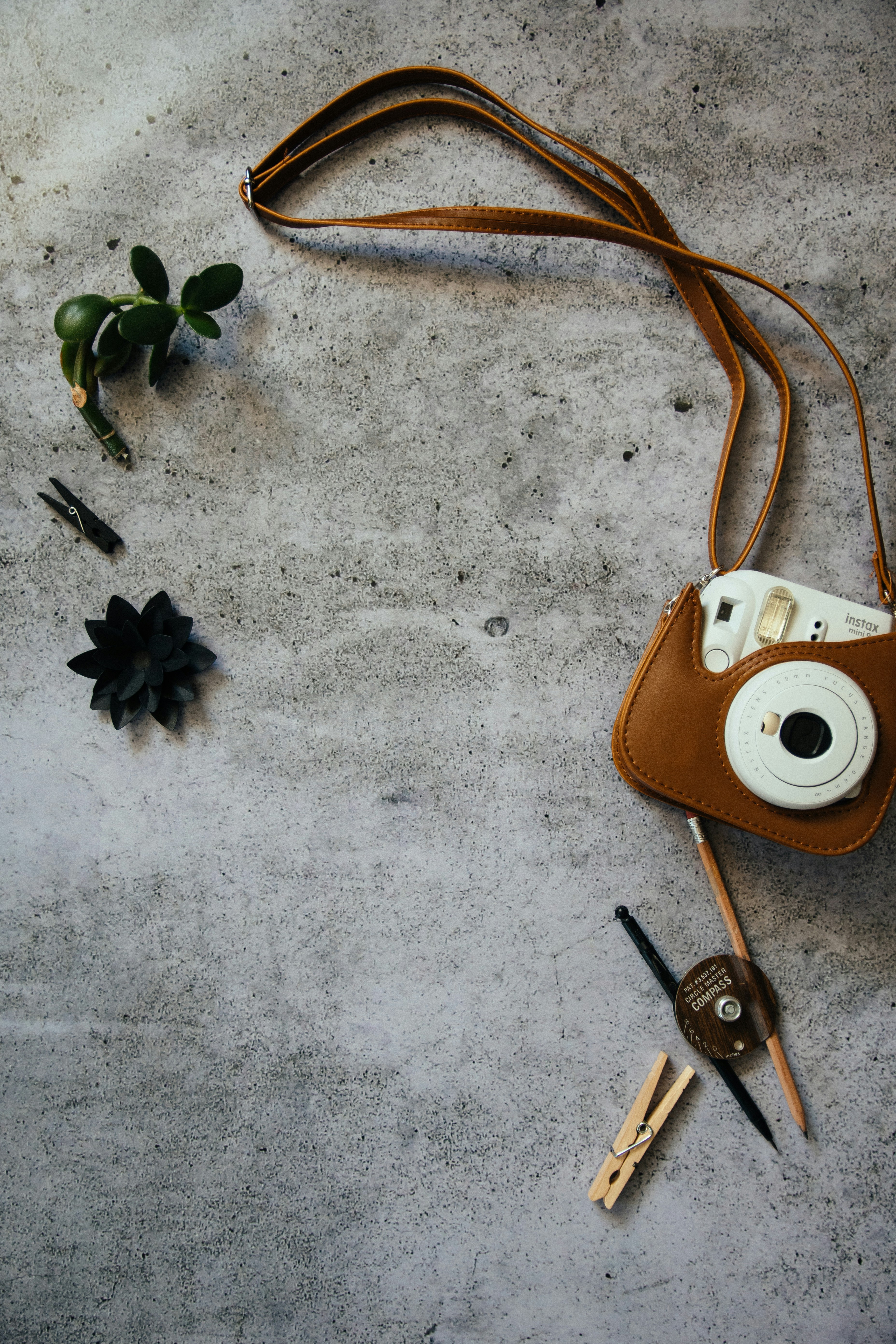 white leather sling bag beside silver keys
