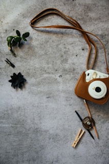 white leather sling bag beside silver keys