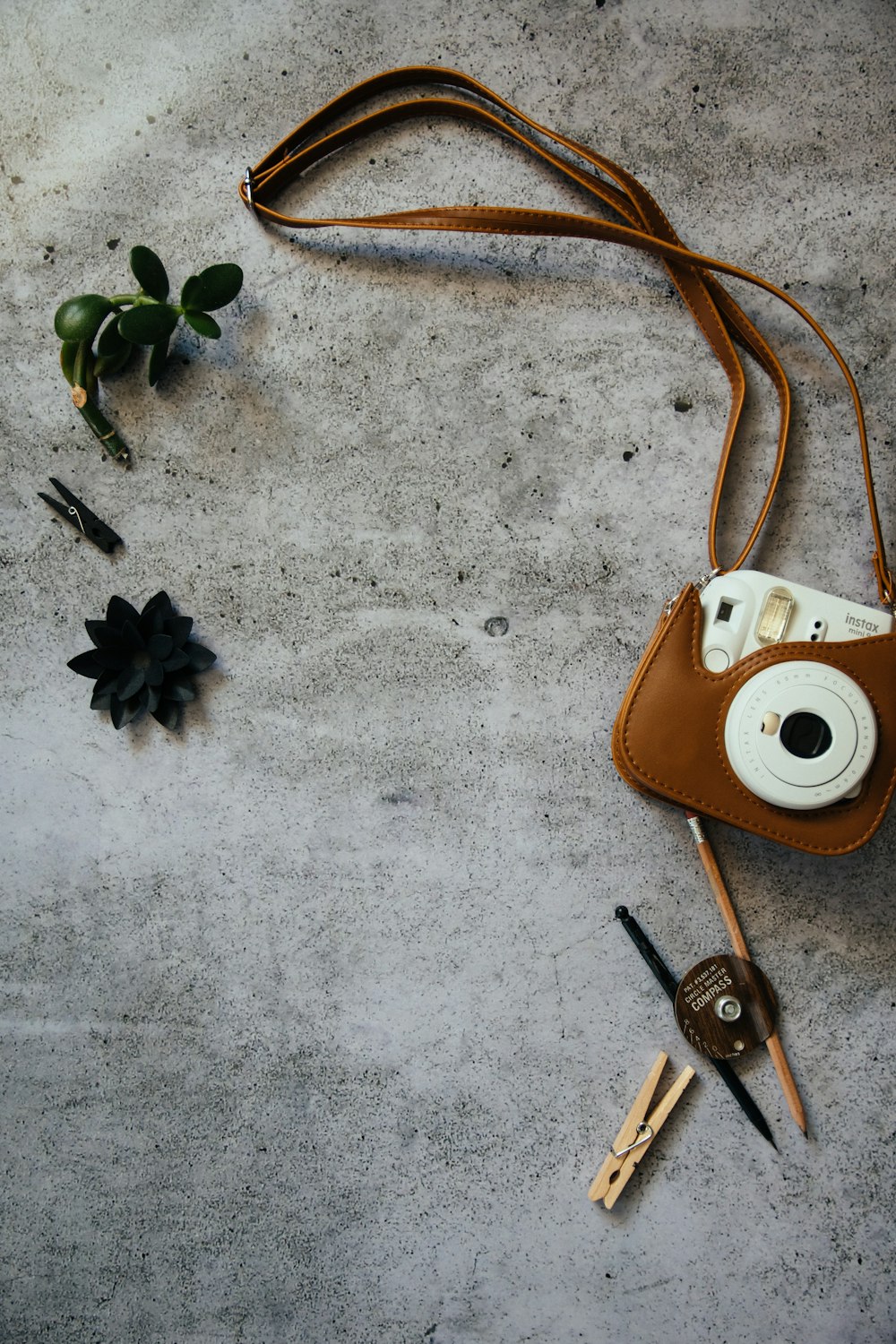 white leather sling bag beside silver keys