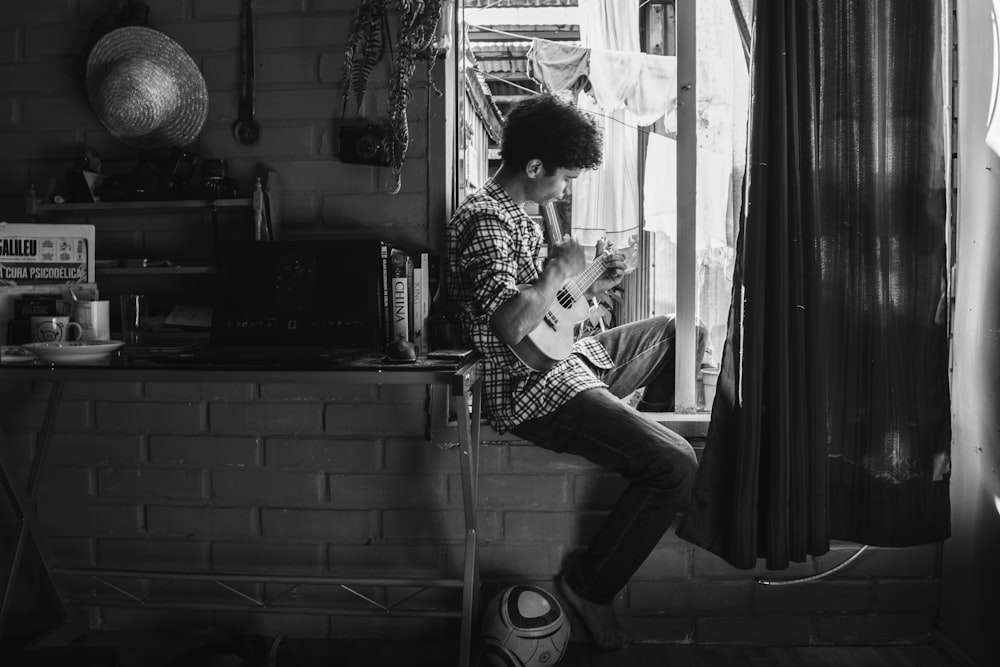 woman in black and white long sleeve shirt sitting on chair