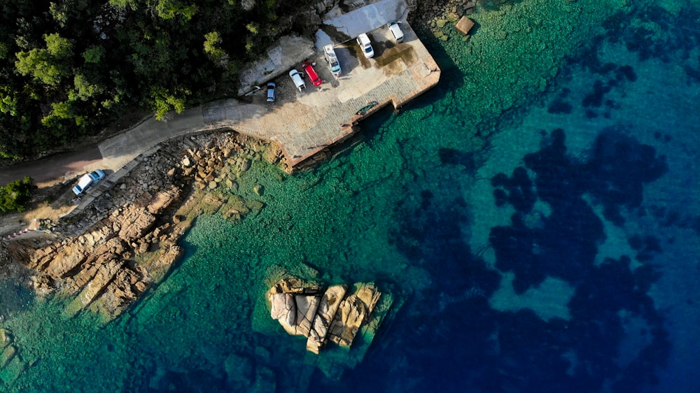 aerial view of white and brown house near body of water during daytime