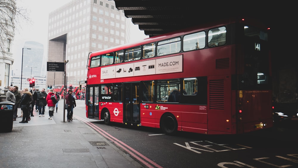 red double decker bus on road during daytime