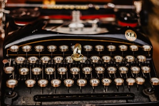 black and silver typewriter on table