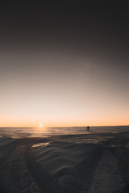 person standing on sand during sunset in Ontario Canada