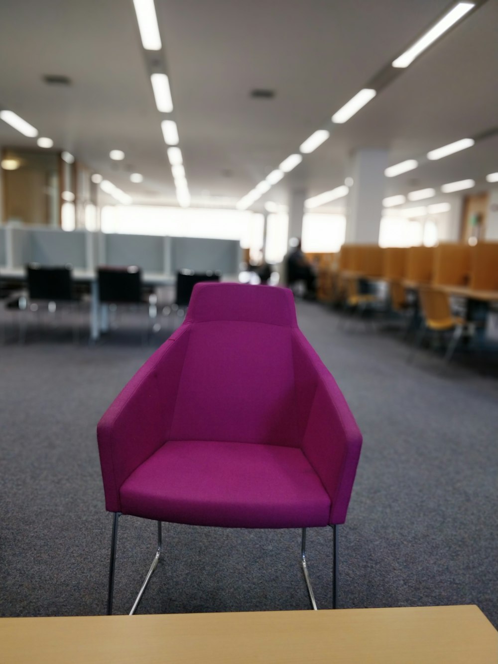 purple chair on gray carpet