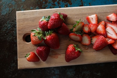 strawberries on brown wooden tray