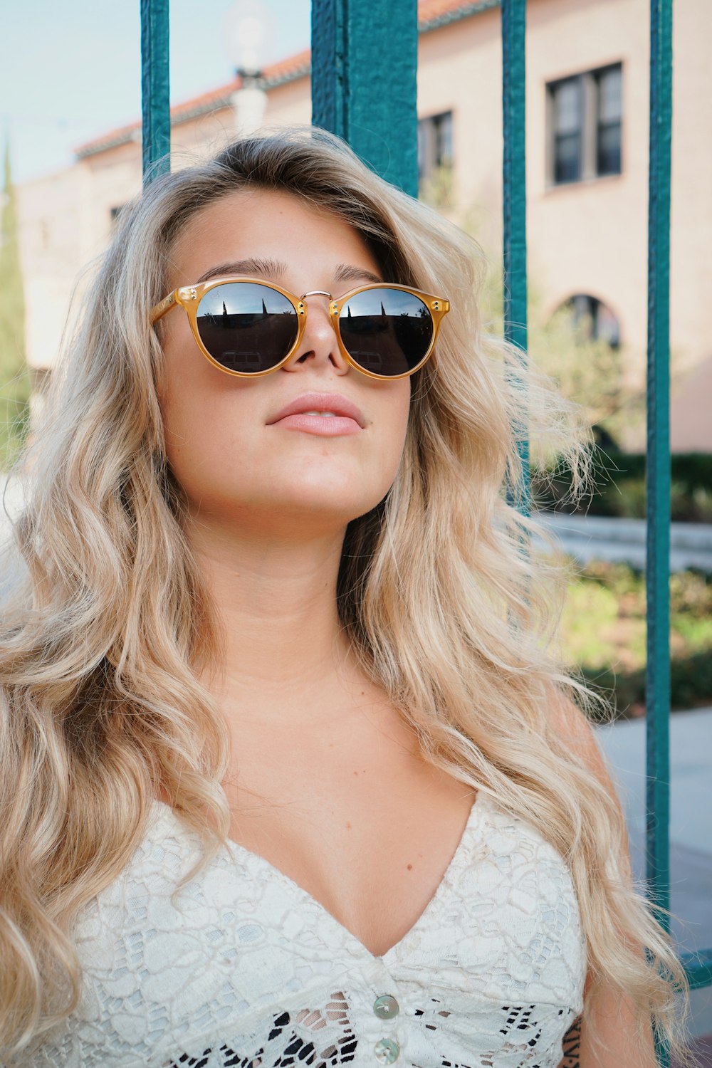 woman in white tank top wearing brown sunglasses