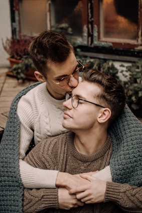 man in gray sweater wearing black framed eyeglasses