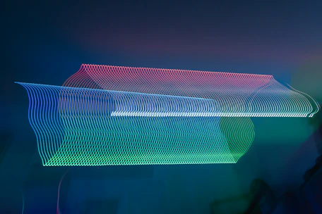 A mesmerizing wave-like animated background glowing with soft blue hues.