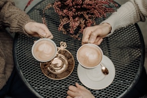 person holding cup of cappuccino