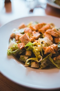 A classic Caesar salad featuring crisp romaine, parmesan shavings, croutons, and creamy dressing.