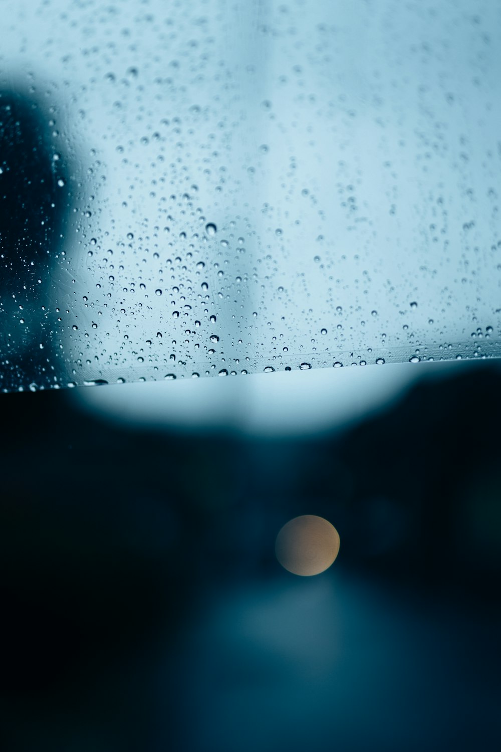 rain drops on a window with a blurry background