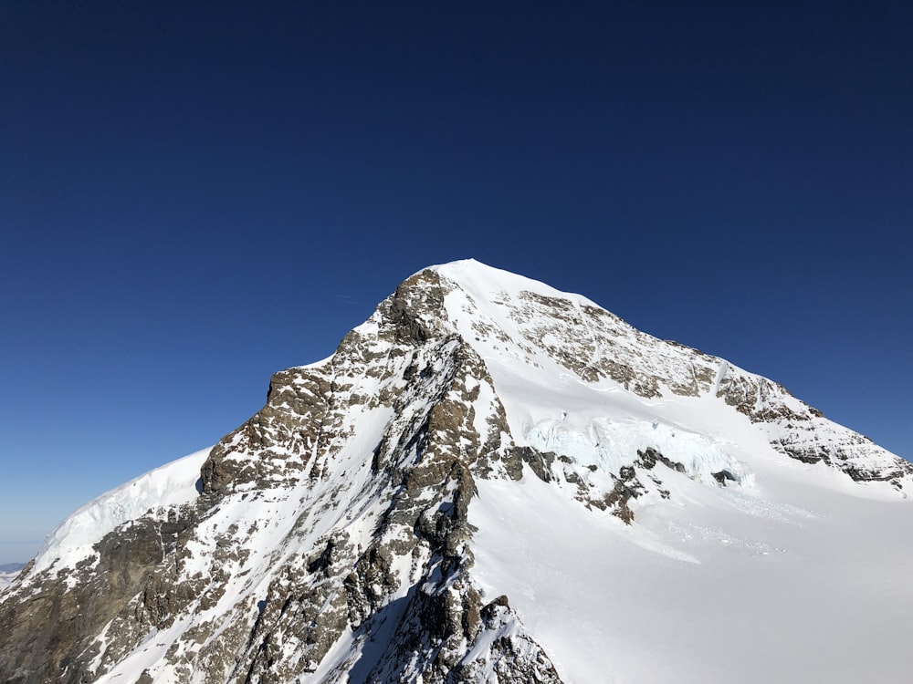 snow covered mountain under blue sky during daytime