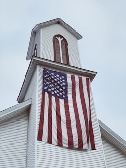 us a flag on white concrete building