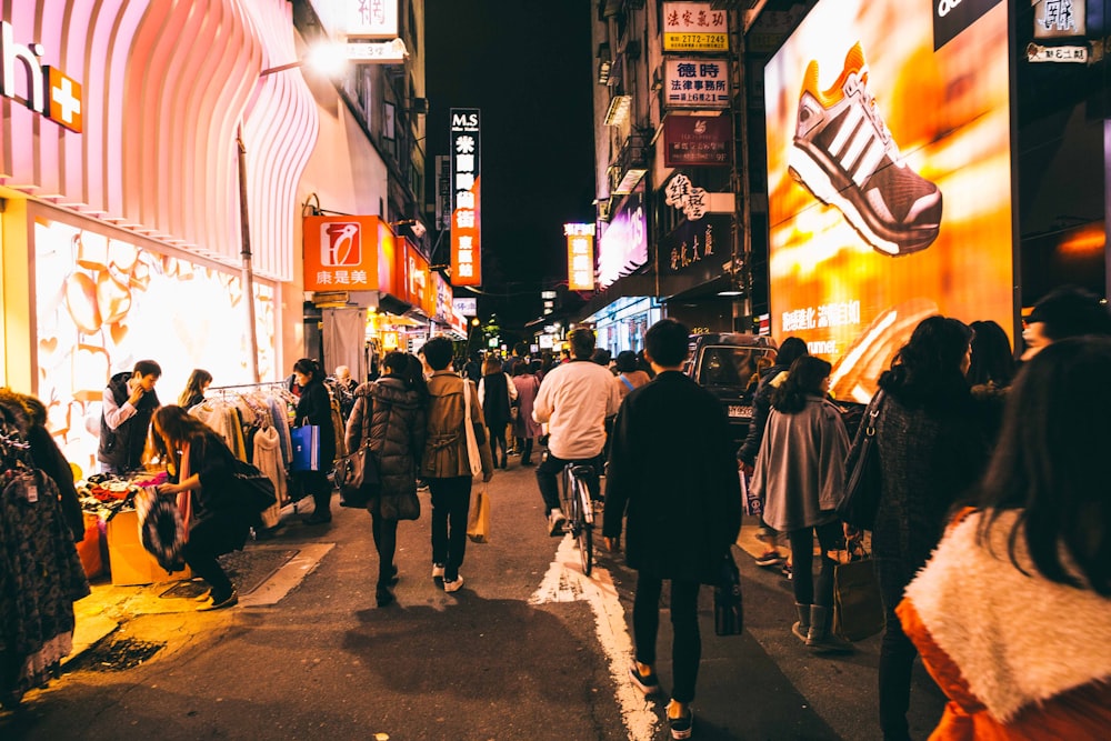 people walking on street during night time