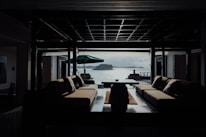 Interior shot of a stylish living room with plush seating and large windows overlooking Yas Marina.