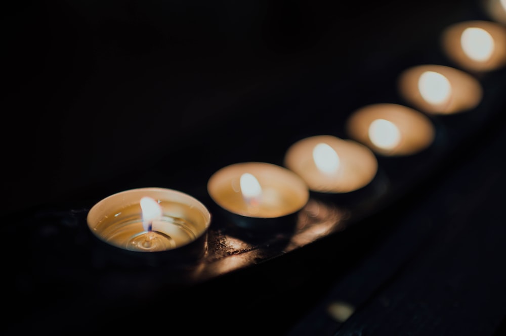 white candles on black tray