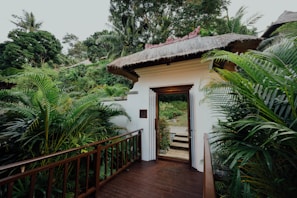 The welcoming entrance of Sawasdee Wellness with wooden accents and greenery.