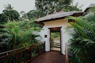 The welcoming entrance of Sawasdee Wellness with wooden accents and greenery.