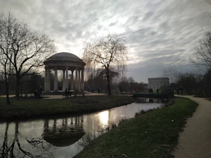 Historic spa colonnade and peaceful park in Karlovy Vary under soft daylight