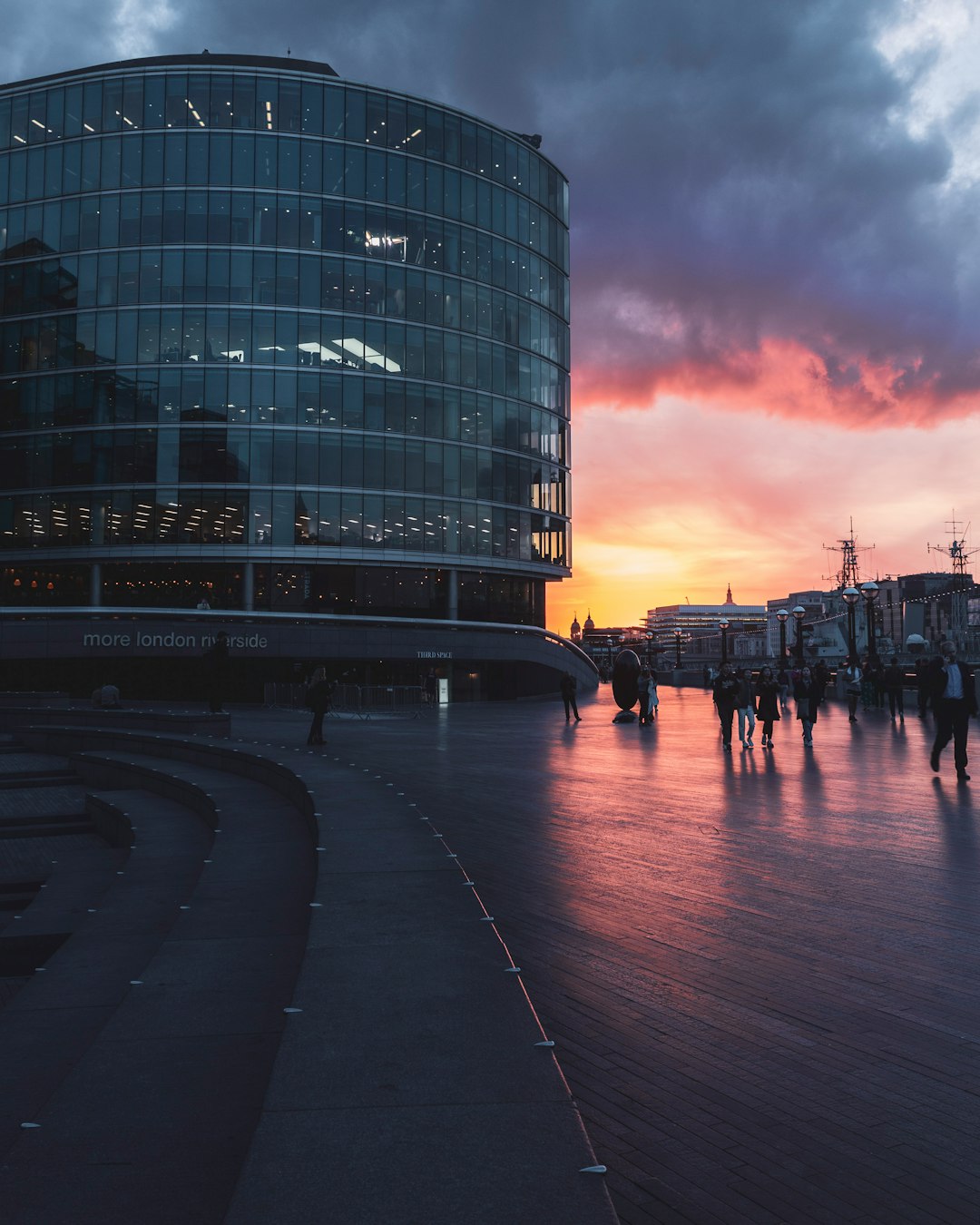 people walking on street near building during sunset