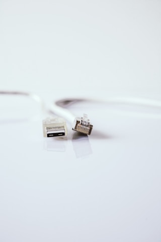 white usb cable on white surface