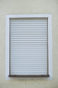Close-up of insulated roller shutter boxes installed on a building facade.