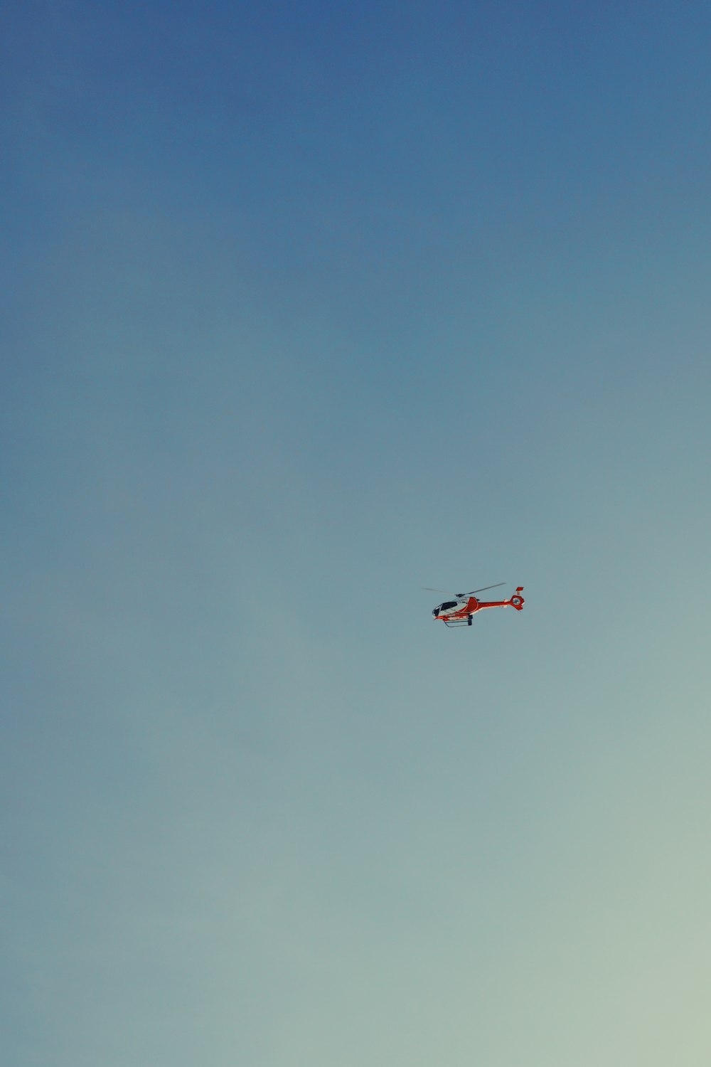 red and white airplane flying in the sky during daytime