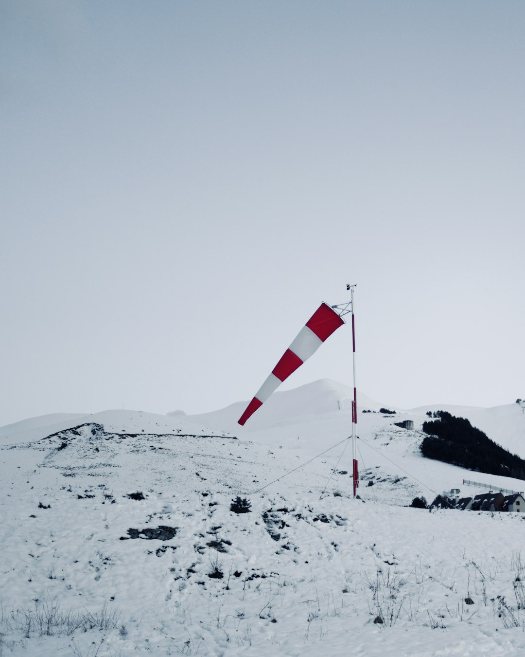 red and white flag on snow covered mountain