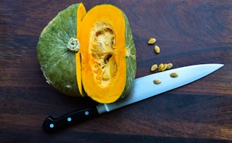 sliced yellow fruit beside knife