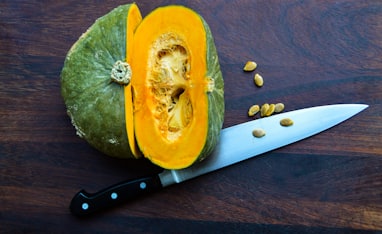sliced yellow fruit beside knife