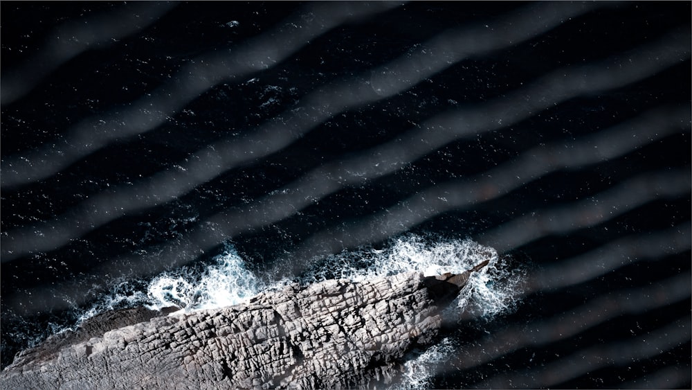 ocean waves crashing on rocky shore during daytime