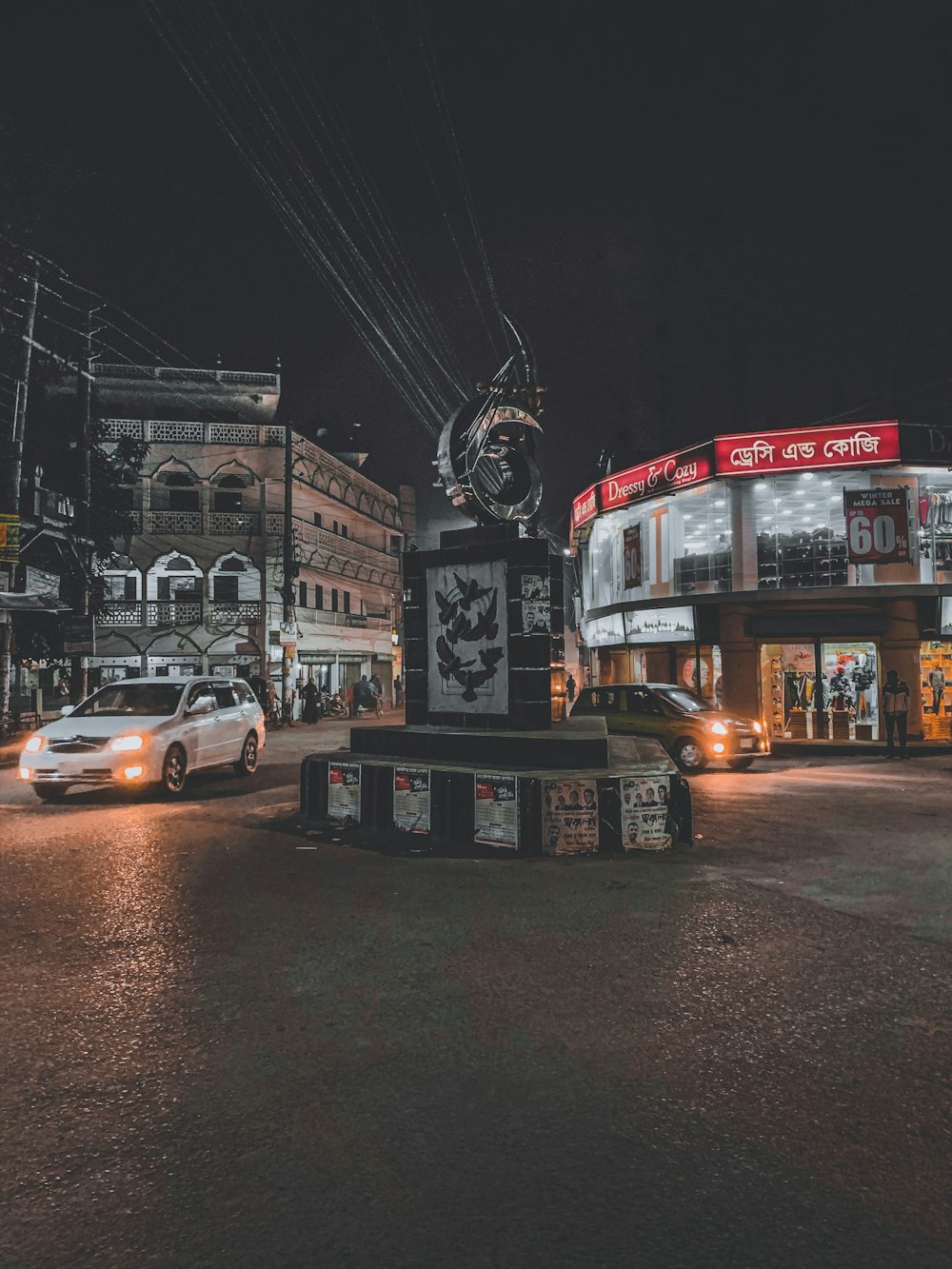 cars parked in front of store during night time