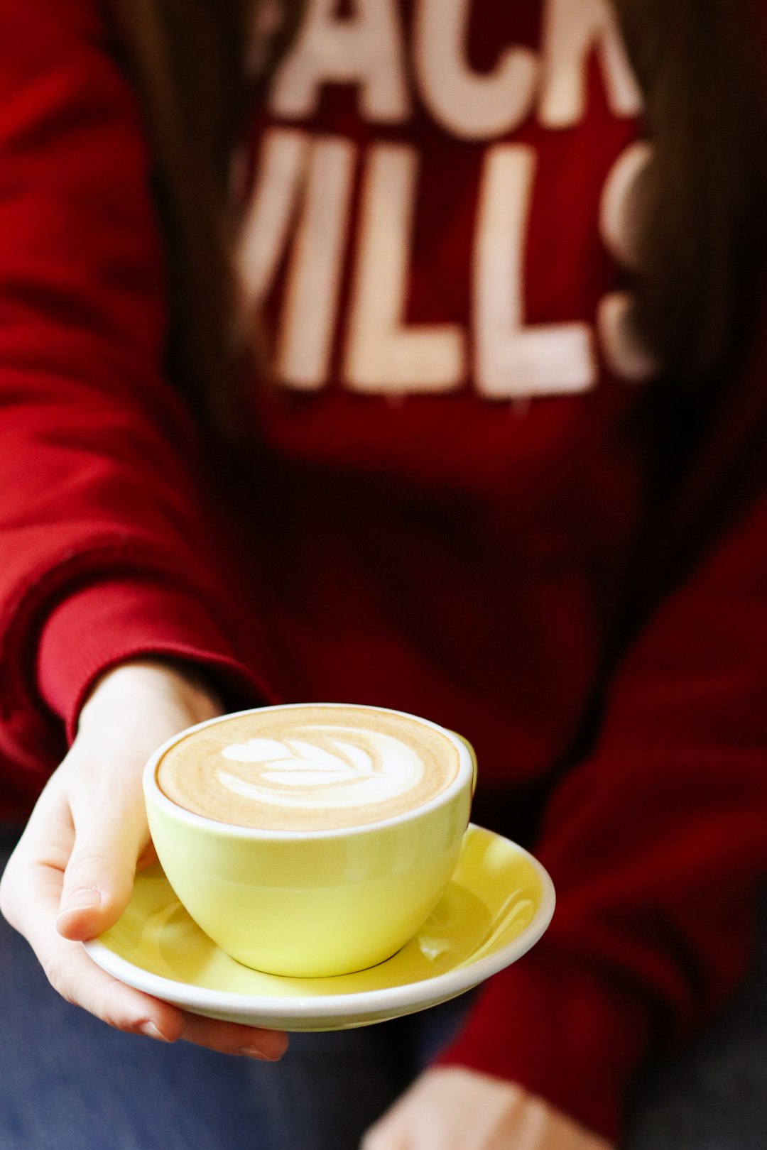 person holding white ceramic mug with coffee