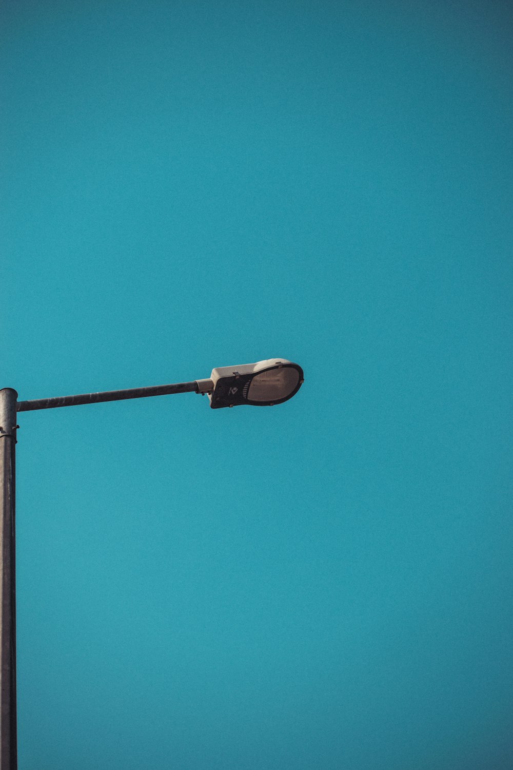 brown and white street light under blue sky during daytime