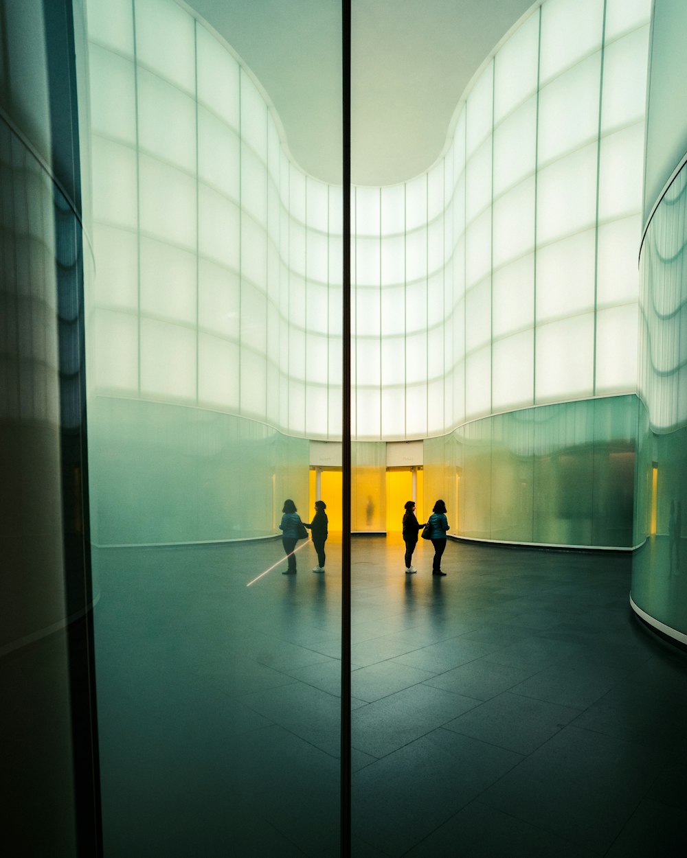 person in black jacket walking on hallway