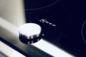 Close-up of stylish kitchen appliances branded with logos.