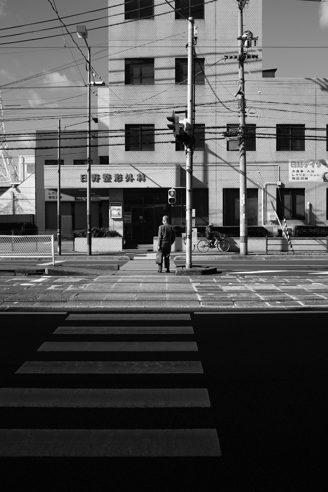 grayscale photo of people walking on pedestrian lane