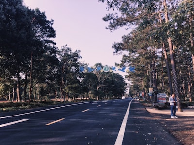 Close-up of a sign showing legally verified land documents beside a paved road.