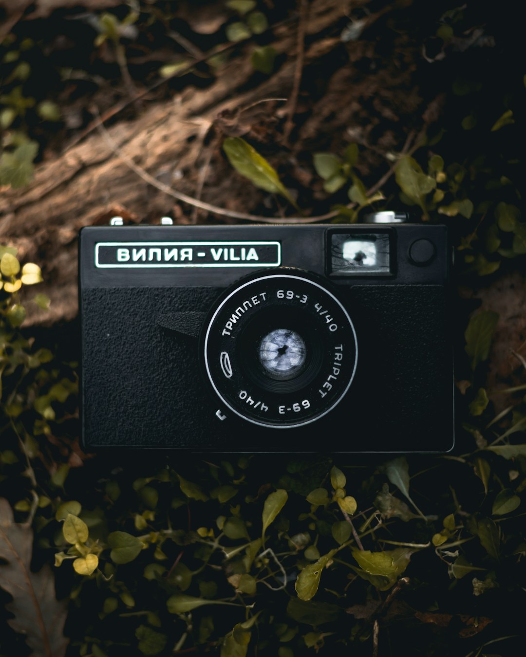 black and silver nikon camera on green grass