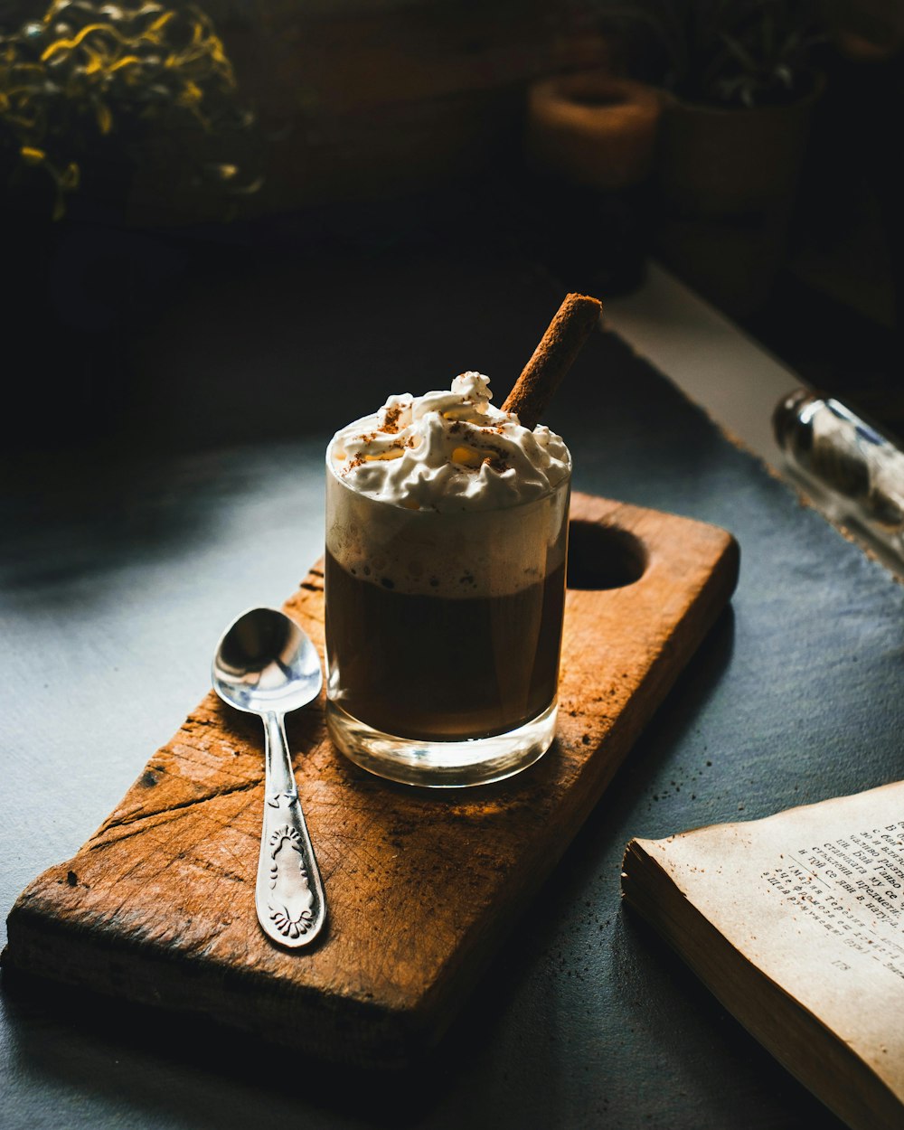 clear glass cup with brown liquid on brown wooden table