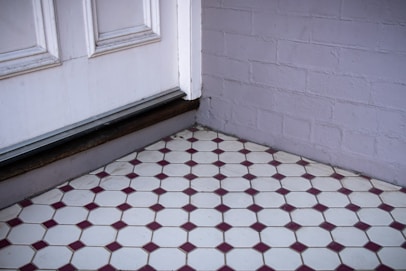 white wooden door on white concrete wall