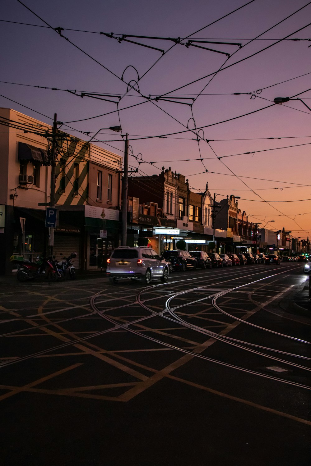 cars parked on side of road during night time