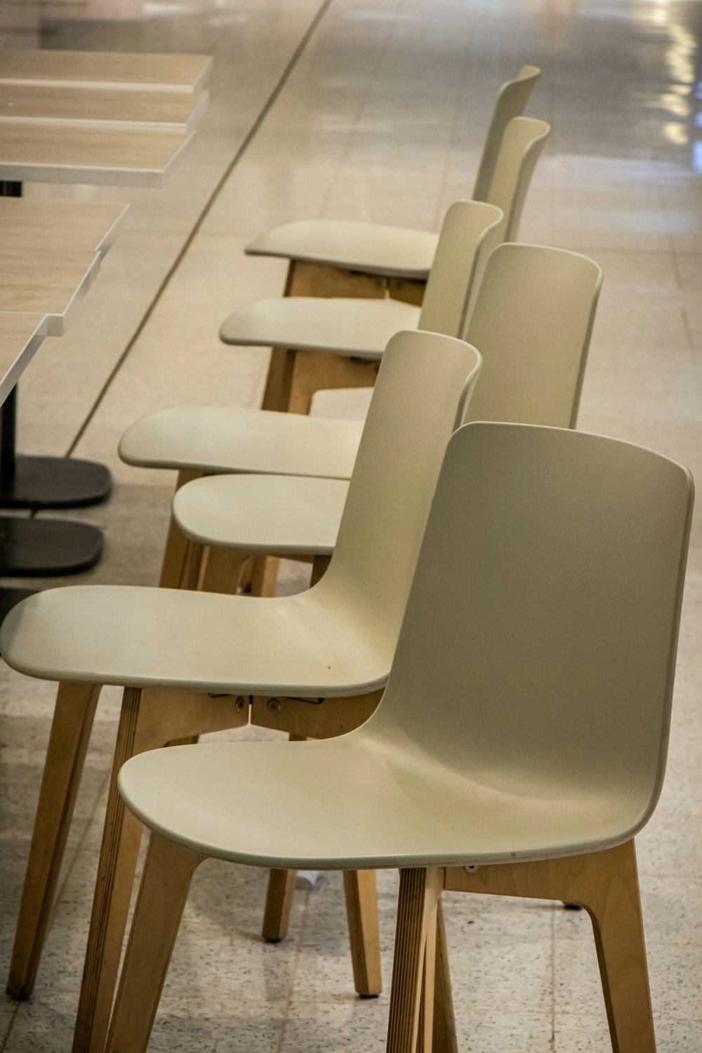 white plastic chairs on white floor tiles