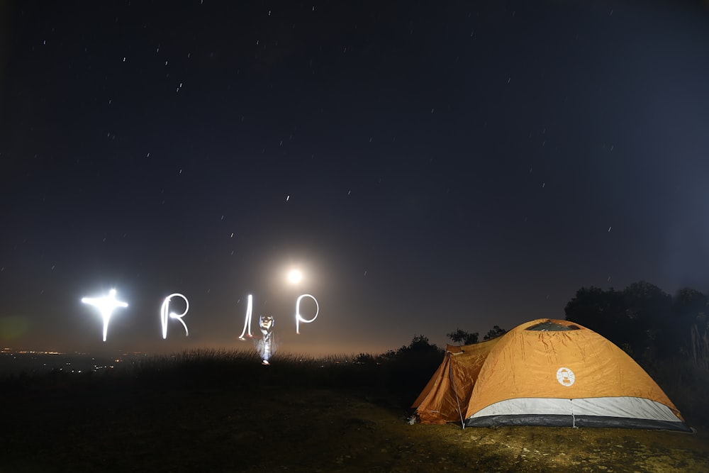 yellow tent under starry night