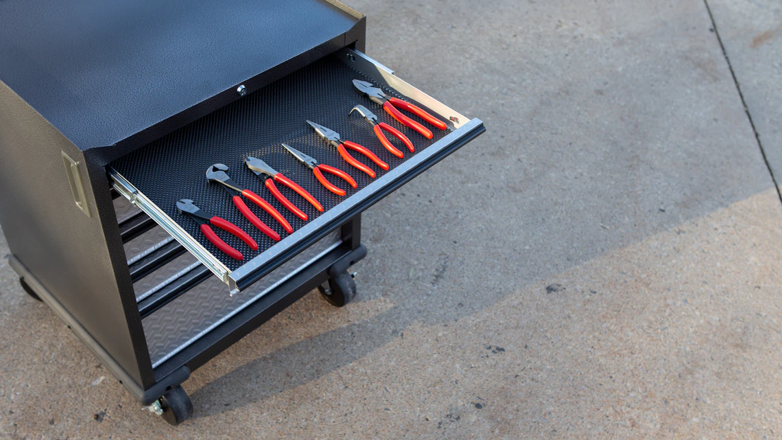 Professional pliers on a workshop surface