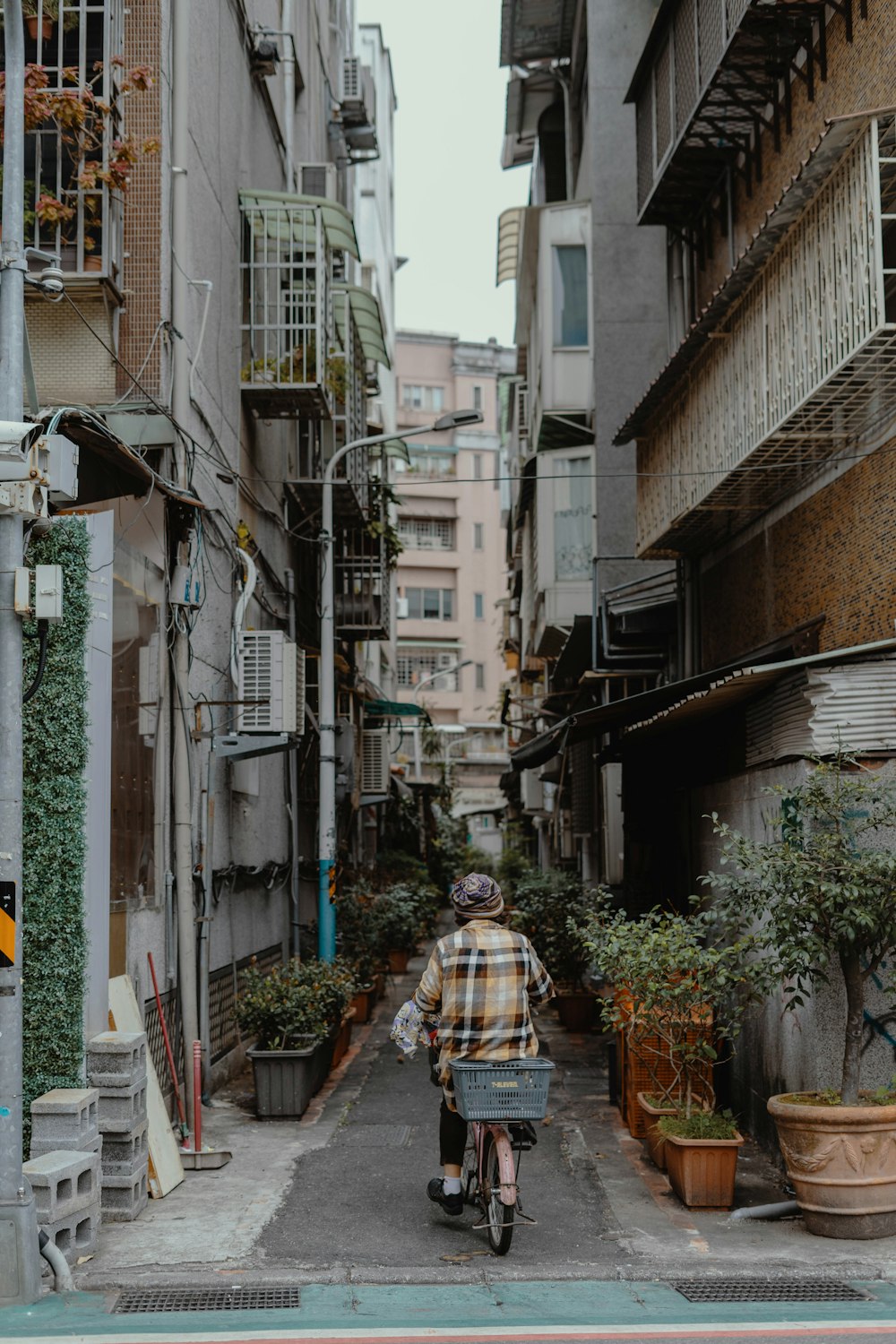 woman in brown jacket walking on street during daytime