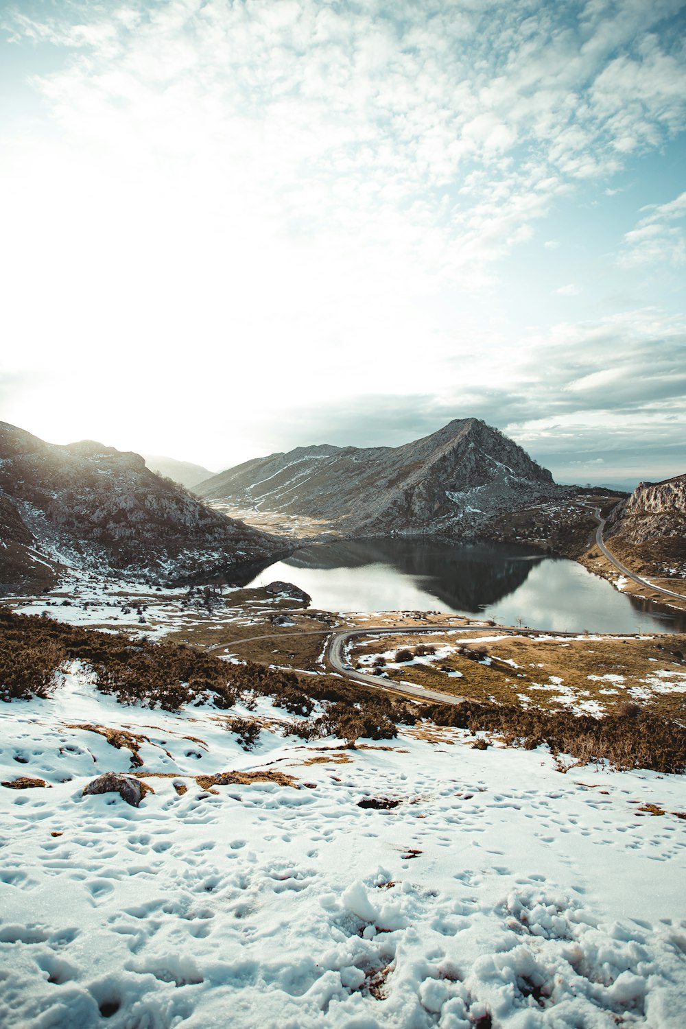 snow covered field and mountains during daytime